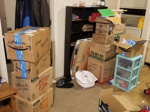 a picture of stacks of boxes in our tiny living room.
